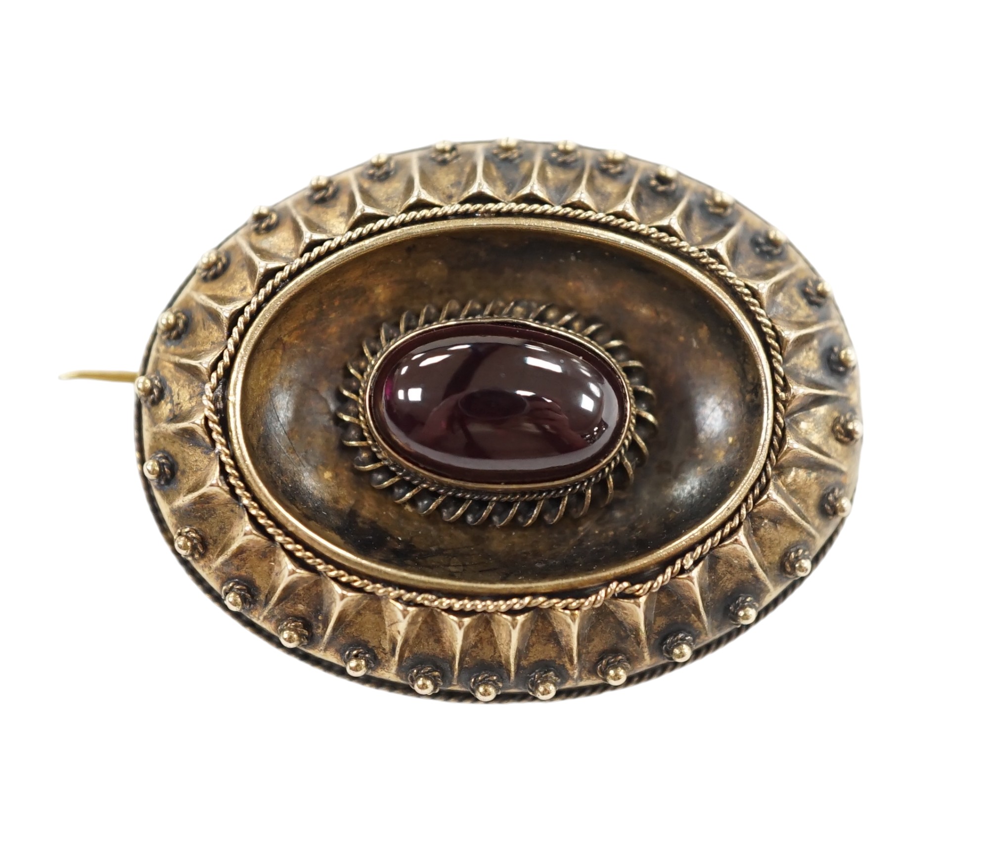 A Victorian yellow metal and single stone oval cabochon garnet set oval brooch, with glazed back, 33mm, gross weight 8.7 grams. Condition - fair